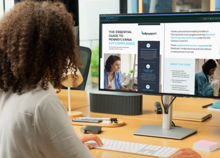 Woman sitting in front of computer reading an EVV guide