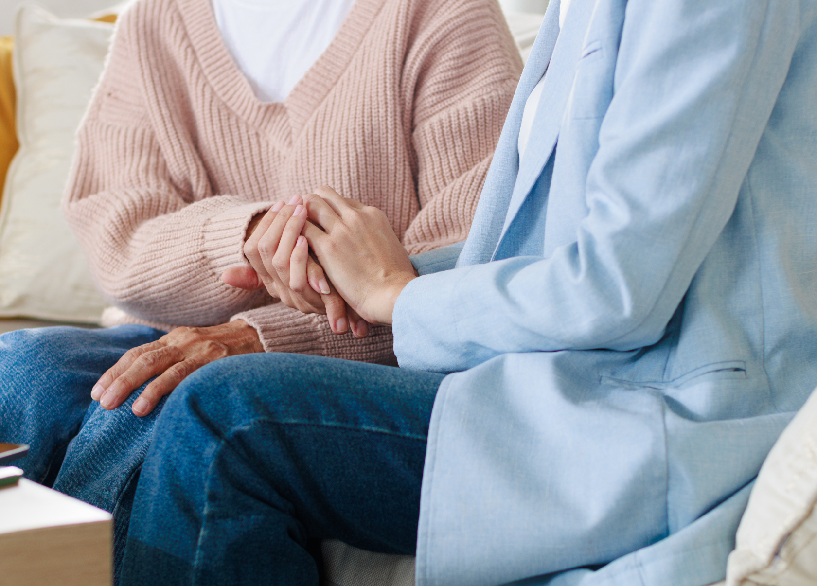 Close-up of two people holding hands